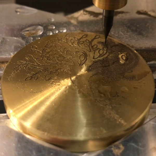 jewelry engraving machine engraving a tree of life in brass