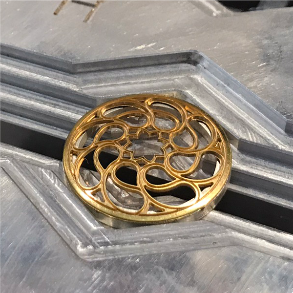 engraving machine for jewelry: flat engraving of a medallion. finished engraved jewelry pendant with the cnc machine for jewelry.